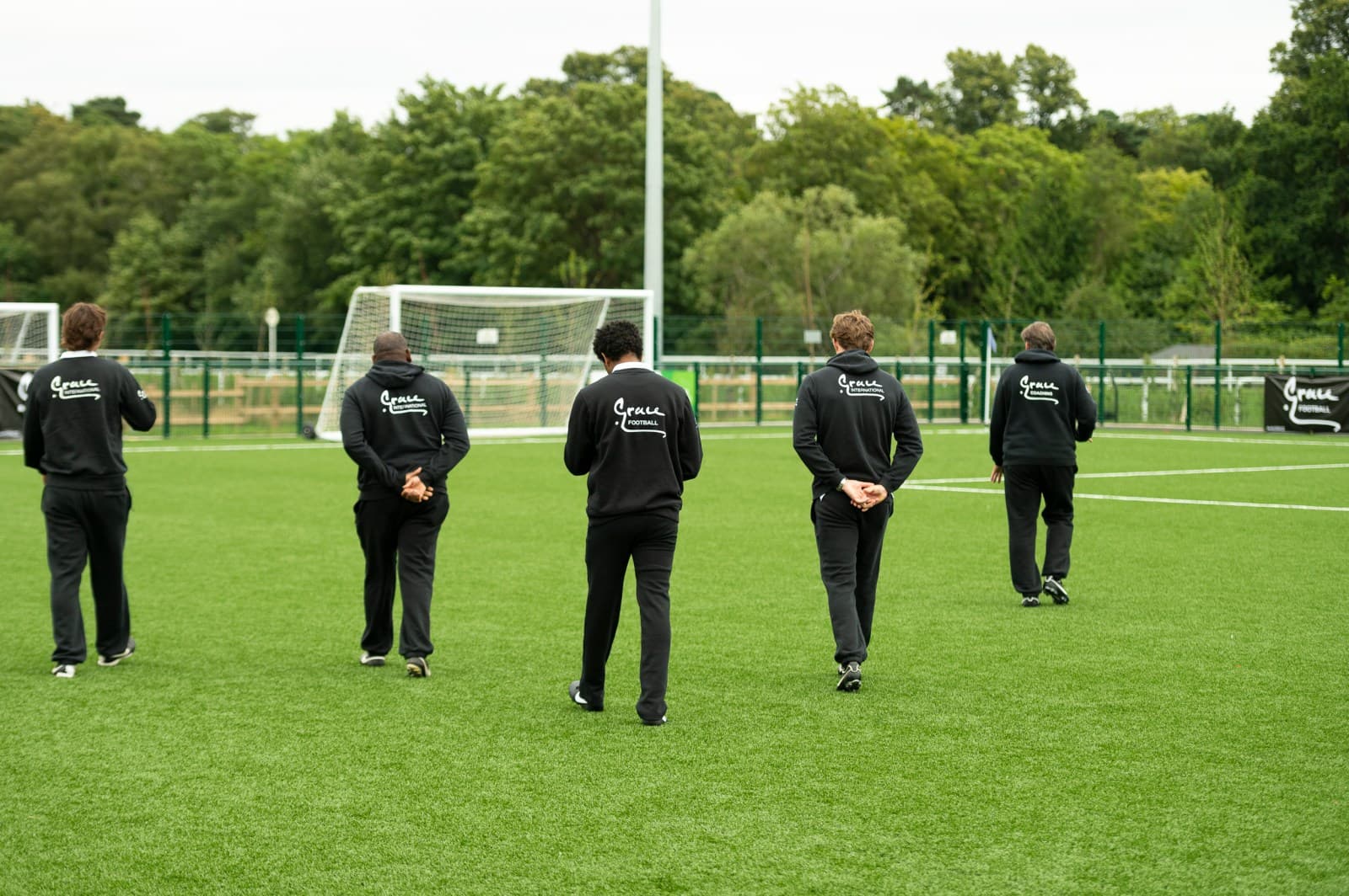 Grace Football coaching staff on the pitch
